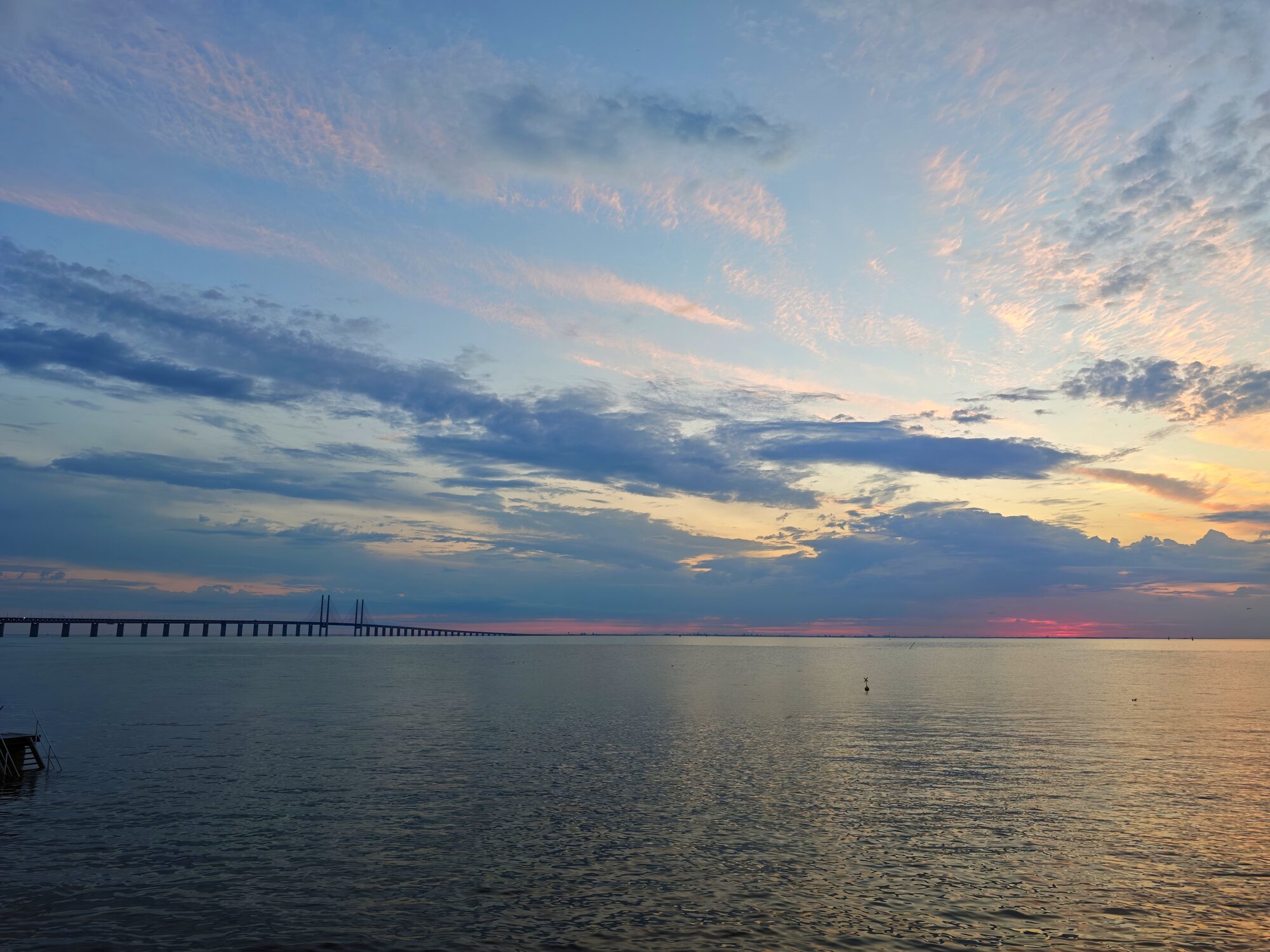 Öresundbrücke bei Sonnenuntergang über ruhigem Wasser